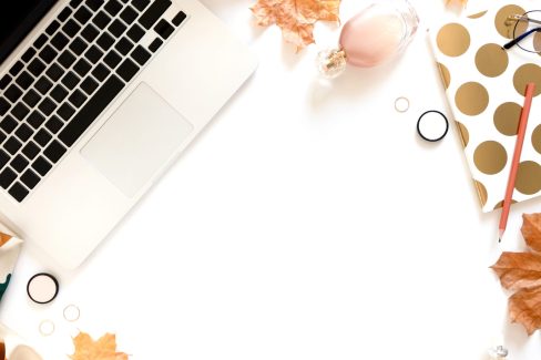 Laptop, cosmetics, notebook on white background
